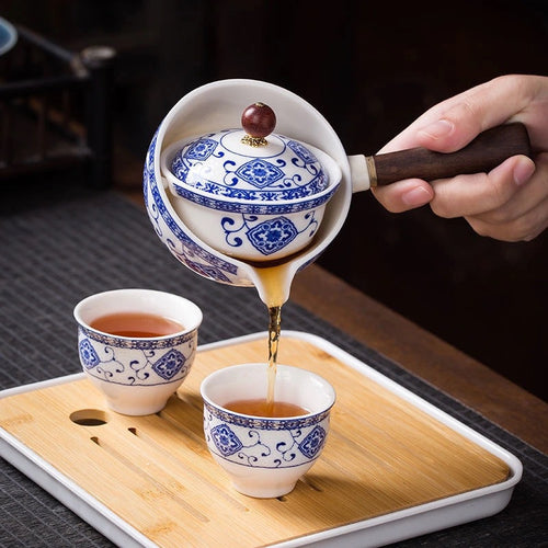 Pouring tea from the blue and white rotating tea maker